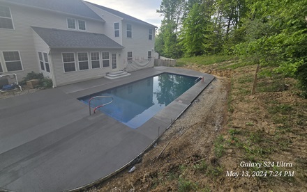 photo of a curved pool concrete patio