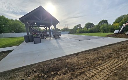 photo of a large concrete patio with a pavilion and pool