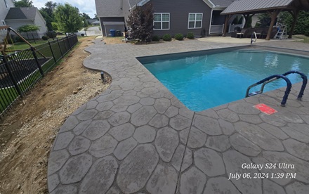 photo of a curved and stamped pool patio
