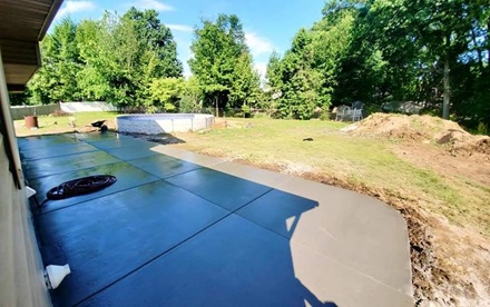 photo of a stamped concrete patio behind a house