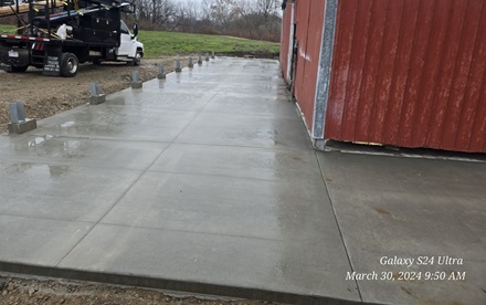 photo of a concrete pad surrounding a pole barn